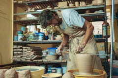 Creating a jar or vase of white clay close-up. Master crock. Stock Photos Creating a jar or vase of white clay close-up. Master crock. Stock Photos