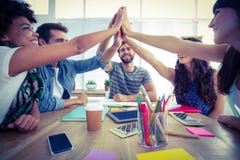 Creative business team putting hands together. At the office Creative business team putting hands together. At the office