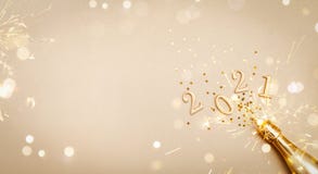 Creative Christmas and New Year greeting card with golden champagne bottle, confetti stars and 2021 numbers. Flat lay. Banner.