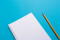 Top view office desk with open mock up notebooks and pencil on blue pastel color background. Top view with copy space, flat lay stock image Top view office desk with open mock up notebooks and pencil on blue pastel color background. Top view with copy space, flat lay stock image