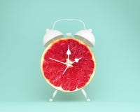 Creative Idea Layout Fresh Grapefruit Slice Alarm Clock On Paste Stock Photography Creative Idea Layout Fresh Grapefruit Slice Alarm Clock On Paste Stock Photography
