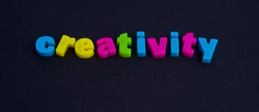 Creativity: possible logo. A macro image of the word creativity in colorful lower case letters isolated on a dark background royalty free stock photo Creativity: possible logo. A macro image of the word creativity in colorful lower case letters isolated on a dark background royalty free stock photo
