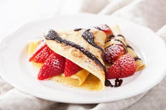 Crepes con la salsa de la fresa y de chocolate imagen de archivo libre de regalías Crepes con la salsa de la fresa y de chocolate imagen de archivo libre de regalías