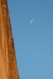 Crescent moon in the daytime behind an ancient wall stock photography Crescent moon in the daytime behind an ancient wall stock photography