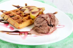 Crispy Belgian Waffle With Pieces Of Pear, Berry And Chocolate Syrup And Ice Cream Balls Royalty Free Stock Image