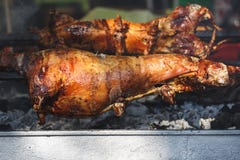 Crispy whole roasted lamb on barbecue spit