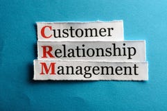 Crm abbreviation. CRM customer relation management abbreviation on blue paper Crm abbreviation. CRM customer relation management abbreviation on blue paper