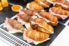 Croissant With Ham And Cheese. Hot Pastries Lie On The Shelf In The Cafe. Buns And Bagels In The Store. Royalty Free Stock Images