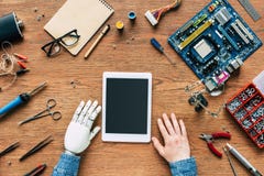 cropped image of electronic engineer with robotic hand sittng at table with digital tablet surrounded royalty free stock image cropped image of electronic engineer with robotic hand sittng at table with digital tablet surrounded royalty free stock image
