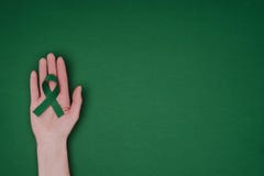 cropped shot of female hand with green awareness ribbon for Green awareness ribbon for Scoliosis, mental health symbol stock image cropped shot of female hand with green awareness ribbon for Green awareness ribbon for Scoliosis, mental health symbol stock image