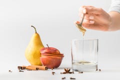 cropped shot of woman pouring honey in glass from spoon stock photo cropped shot of woman pouring honey in glass from spoon stock photo