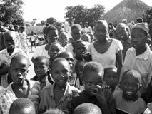 Crowd African curious children gathering as aid relief workers arrive stock photo Crowd African curious children gathering as aid relief workers arrive stock photo