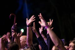 Crowd of people with their hands up during the rock concert on dark background royalty free stock image Crowd of people with their hands up during the rock concert on dark background royalty free stock image