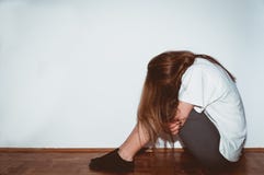Crying woman abused as young feeling depressed and miserable while she sitting alone in her room stock photos Crying woman abused as young feeling depressed and miserable while she sitting alone in her room stock photos
