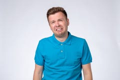 Crying young man in blue t-shirt looking at camera, crying because he lost his job or girlfriend. royalty free stock photos Crying young man in blue t-shirt looking at camera, crying because he lost his job or girlfriend. royalty free stock photos