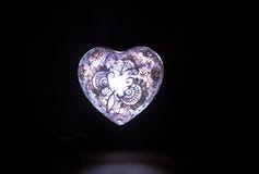 Crystal light white glass heart in the dark stock photos Crystal light white glass heart in the dark stock photos