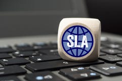 Cube on laptop keyboard with SLA Service-Level-Agreement royalty free stock image Cube on laptop keyboard with SLA Service-Level-Agreement royalty free stock image