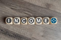 Cubes dice on wooden background with income royalty free stock images Cubes dice on wooden background with income royalty free stock images