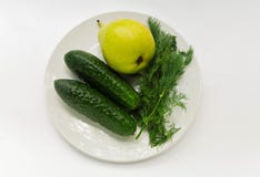 Cucumber, pear, parsley on a white plate stock photos Cucumber, pear, parsley on a white plate stock photos