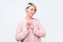 Cunning beautiful woman with dyed hair looking at camera indenting to realize tricky plan royalty free stock photo Cunning beautiful woman with dyed hair looking at camera indenting to realize tricky plan royalty free stock photo