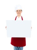 Cuoco unico femminile che visualizza il bordo bianco in bianco dell'annuncio fotografie stock Cuoco unico femminile che visualizza il bordo bianco in bianco dell'annuncio fotografie stock