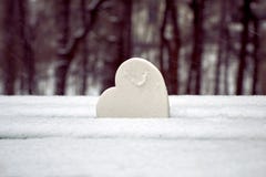 Cuore bianco sul banco di parco innevato Simbolo di amore puro fotografia stock Cuore bianco sul banco di parco innevato Simbolo di amore puro fotografia stock