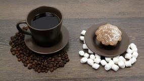 Cup of coffee with beans and marshmallow on the wooden table, delicious dessert royalty free stock photos Cup of coffee with beans and marshmallow on the wooden table, delicious dessert royalty free stock photos