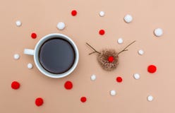 Cup of coffee with Christmas reindeer pompom on brown paper stock images Cup of coffee with Christmas reindeer pompom on brown paper stock images