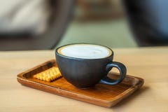 A Cup of coffee latte with cracker. close up. light breakfast. stock photography A Cup of coffee latte with cracker. close up. light breakfast. stock photography