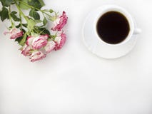 A cup of coffee on a white background and roses coffee stock photos A cup of coffee on a white background and roses coffee stock photos