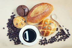 Cup of espresso coffee and many fresh baked breads on white shab Royalty Free Stock Photography Cup of espresso coffee and many fresh baked breads on white shab Royalty Free Stock Photography