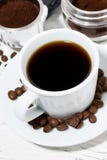 Cup of freshly brewed black coffee on a white table, top view. Vertical royalty free stock image Cup of freshly brewed black coffee on a white table, top view. Vertical royalty free stock image