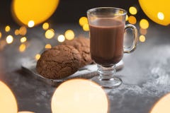 A cup of hot chocolate with chocolate cookies and lights royalty free stock photography A cup of hot chocolate with chocolate cookies and lights royalty free stock photography
