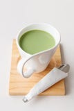 Cup of hot milk green tea on white table Stock Images Cup of hot milk green tea on white table Stock Images