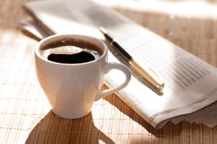 Cup Of Black Coffee, Newspaper And A Pen Against Stock Images