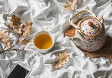 Cup Of Green Tea, Headphones, Player, Teapot In Bed, Top View. Lazy Morning, Warm Autumn Mood. Royalty Free Stock Images