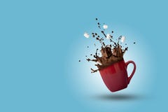 Cup Of Splashing Hot Chocolate With Marshmallows As Gift Boxes Shape On Blue Background. Christmas And New Year Holidays Concept. Royalty Free Stock Photos Cup Of Splashing Hot Chocolate With Marshmallows As Gift Boxes Shape On Blue Background. Christmas And New Year Holidays Concept. Royalty Free Stock Photos