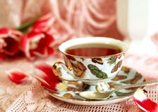 Cup Of Tea And Pink Tulips Stock Images
