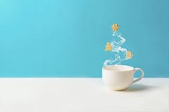 Cup Of Tea Or Coffee With Steam In Fir Tree Shape With Gingerbread Cookies On Blue Background. Christmas Celebration Concept. Copy Stock Photos Cup Of Tea Or Coffee With Steam In Fir Tree Shape With Gingerbread Cookies On Blue Background. Christmas Celebration Concept. Copy Stock Photos