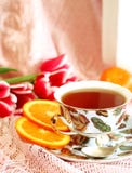Cup Of Tea, Orange And Tulips Royalty Free Stock Photography