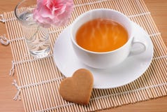 Cup of tea with a heart shaped biscuit Royalty Free Stock Image Cup of tea with a heart shaped biscuit Royalty Free Stock Image