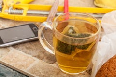 Cup of tea and smartphone in messy interior Stock Photos Cup of tea and smartphone in messy interior Stock Photos