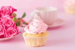 Cupcake With Pink Cream Decoration And Roses On Pink Pastel Background. Stock Image Cupcake With Pink Cream Decoration And Roses On Pink Pastel Background. Stock Image
