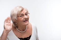 Curious granny trying to hear something stock image Curious granny trying to hear something stock image