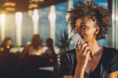Curly black girl using her phone as voice recorder royalty free stock images Curly black girl using her phone as voice recorder royalty free stock images