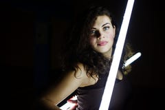 Curly brunette plus size model with two long led lamp