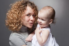 Curly Mother Talking To Cute Smiling Baby Royalty Free Stock Photography Curly Mother Talking To Cute Smiling Baby Royalty Free Stock Photography
