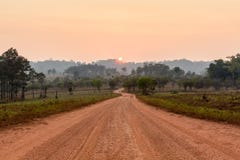 Curve road in the valley with sunrise and mist stock photos Curve road in the valley with sunrise and mist stock photos