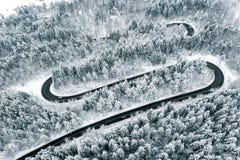 Curved winding road in the forest in winter time stock photo Curved winding road in the forest in winter time stock photo