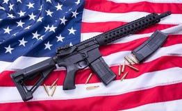 Custom built AR-15 carbine, bullets and a magazine on American flag surface, background. Studio shot. stock images Custom built AR-15 carbine, bullets and a magazine on American flag surface, background. Studio shot. stock images